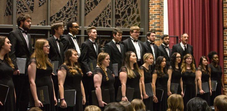 HSU choir formally dressed singing on stage